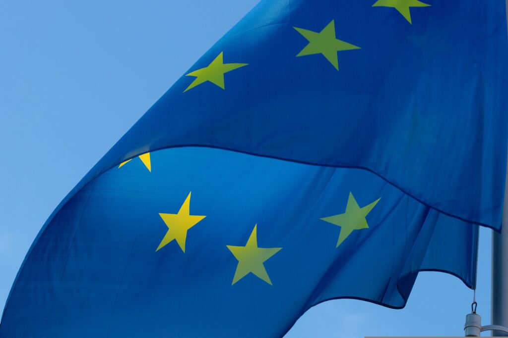 a Close up of a European flag on a pole.