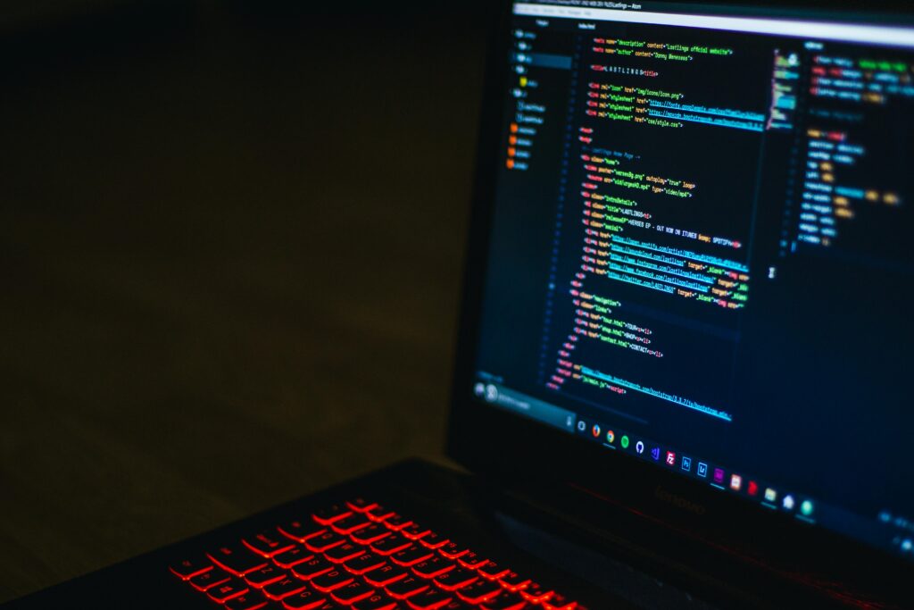 A laptop with html code on screen.