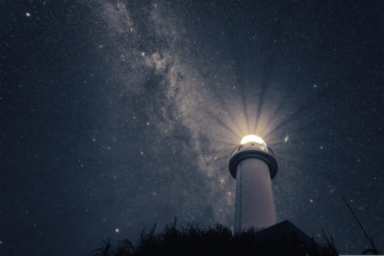 A lighthouse with the night sky in the background.