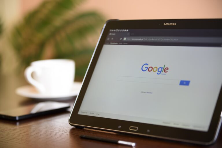 A tablet on a desk with Google search on screen