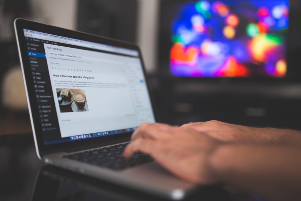 Laptop with hands working on Wordpress