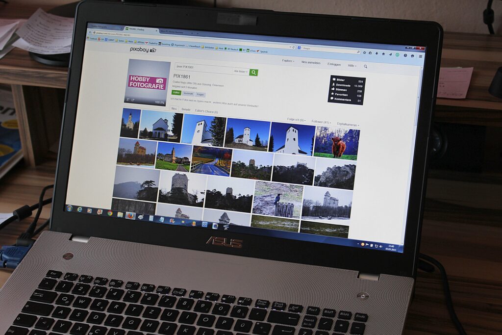 a Laptop with only the screen fully visible. Showing a website with multiple images.