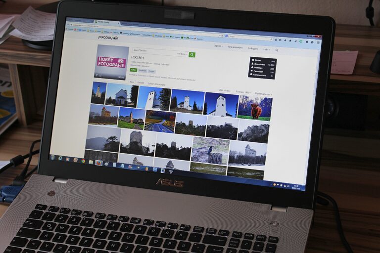 a Laptop with only the screen fully visible. Showing a website with multiple images.